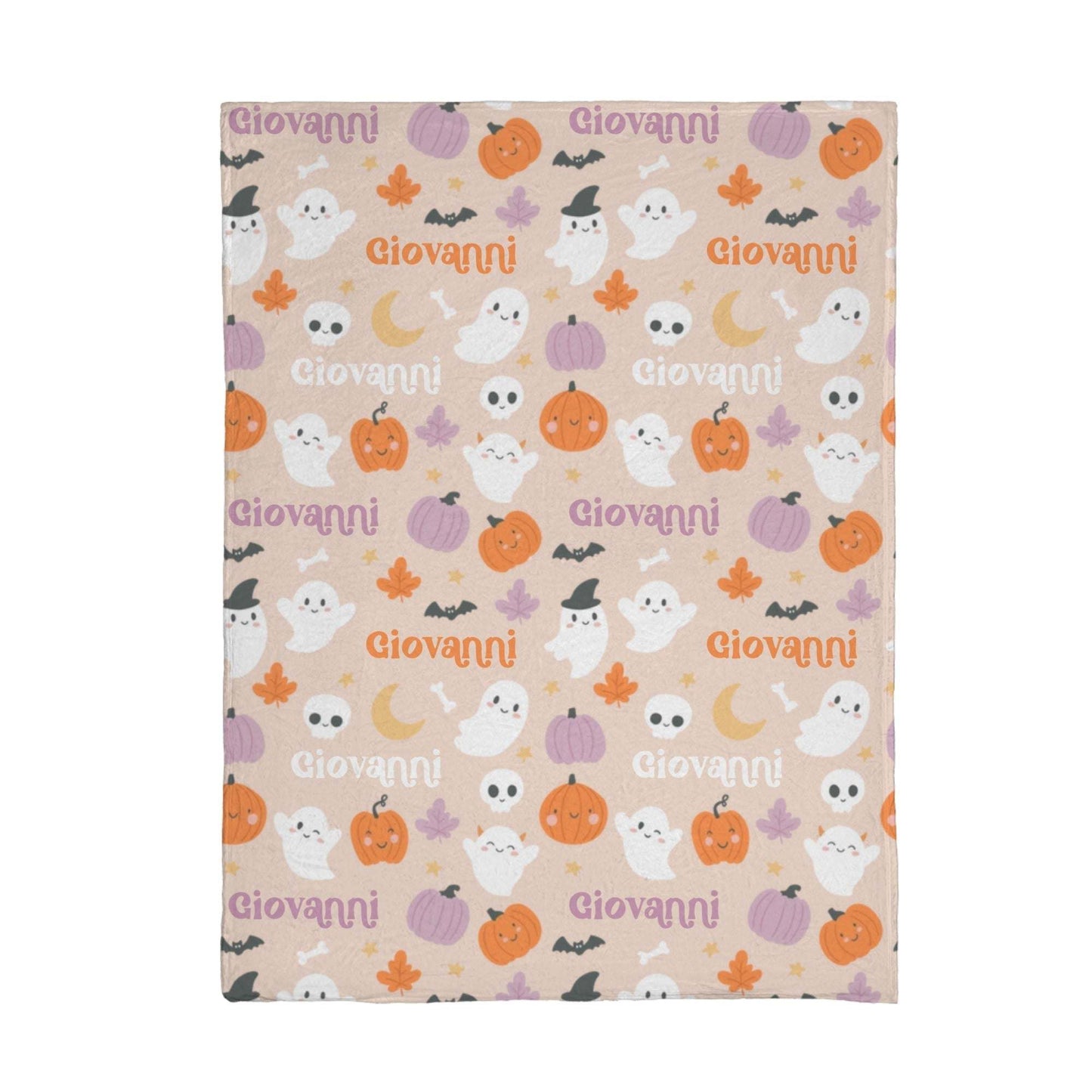 Halloween Mink Touch fleece blanket with custom name, featuring ghosts, pumpkins, bats, and skulls on a soft pink background