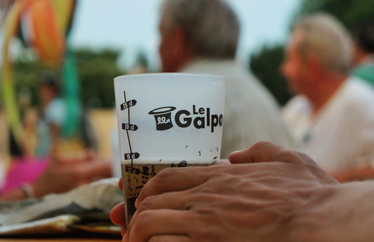 a person holding a coffee cup in their hand