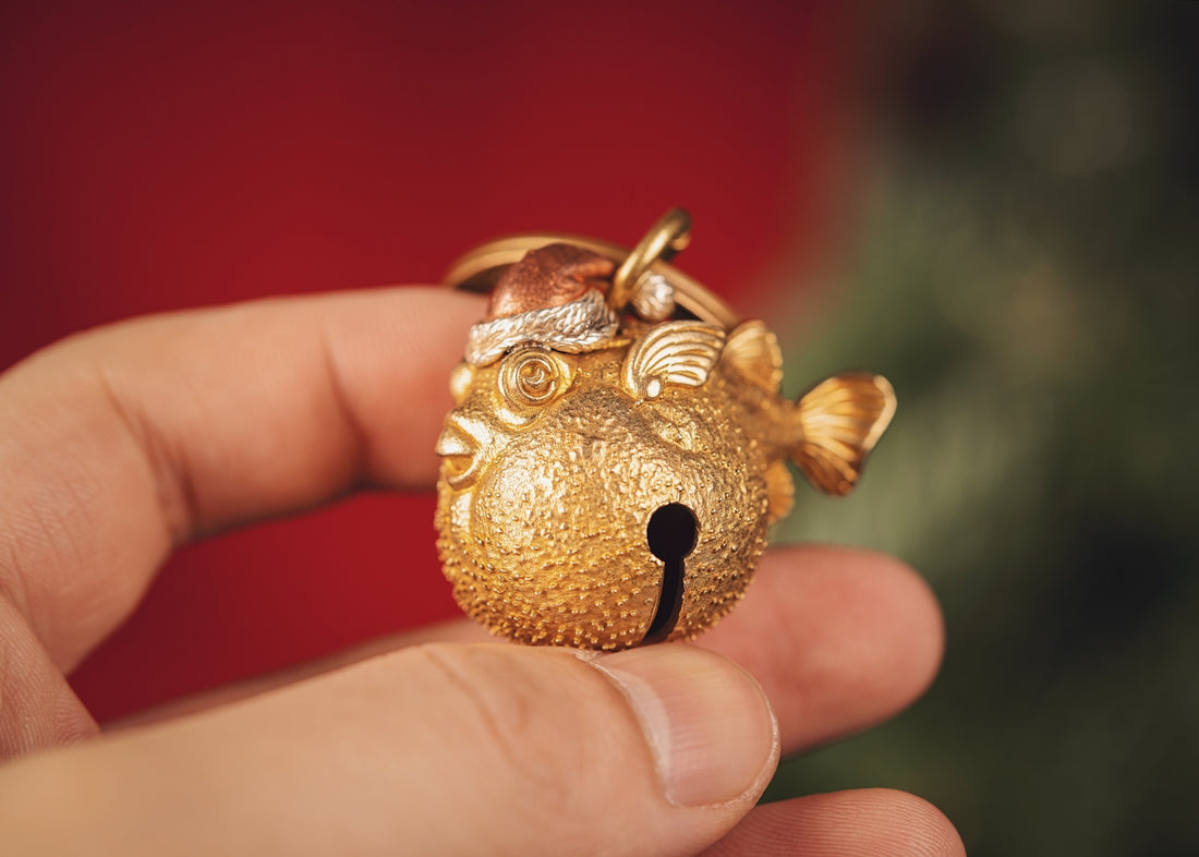 a hand holding a small brown animal