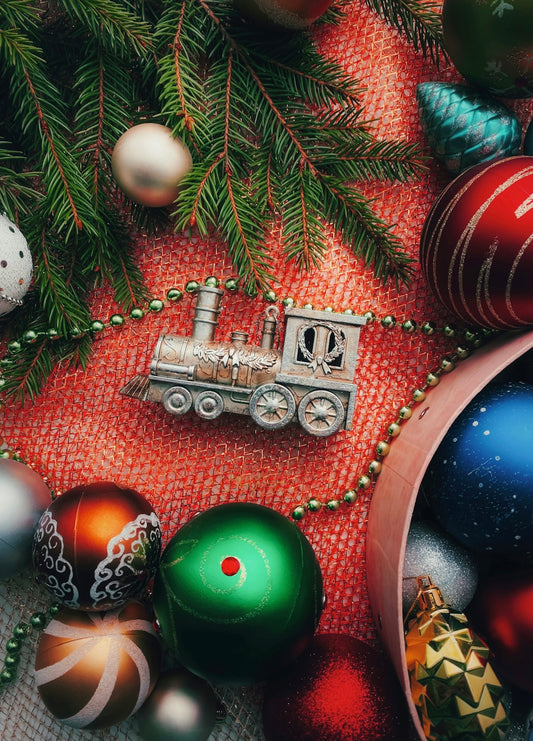 A christmas tree with ornaments and a train ornament