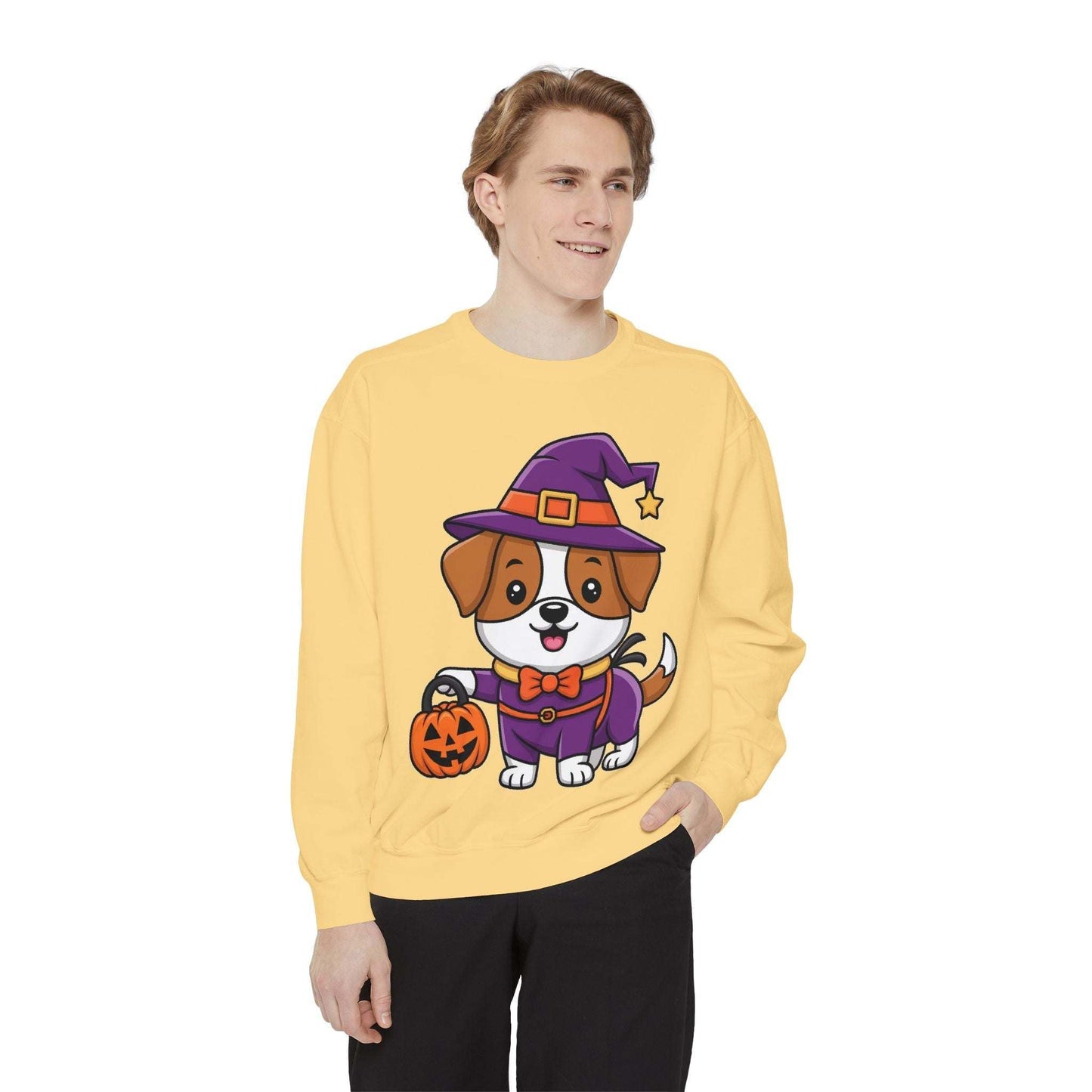 Man wearing yellow sweatshirt with cartoon dog in Halloween witch costume holding pumpkin bucket design