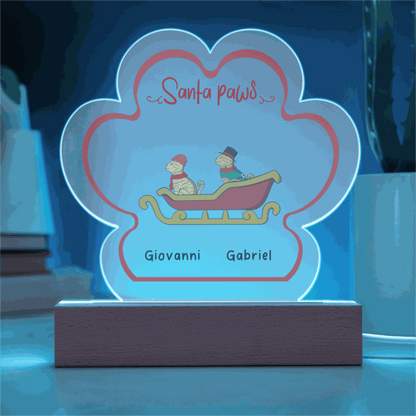 LED-lit acrylic paw print Christmas plaque with custom pet names and festive design on wooden base