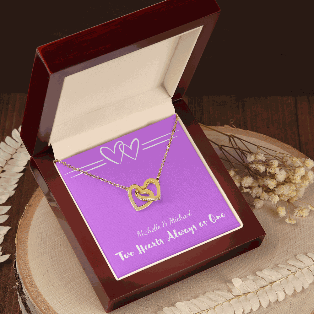 Interlocking Hearts necklace with two gold heart pendants in a luxury gift box