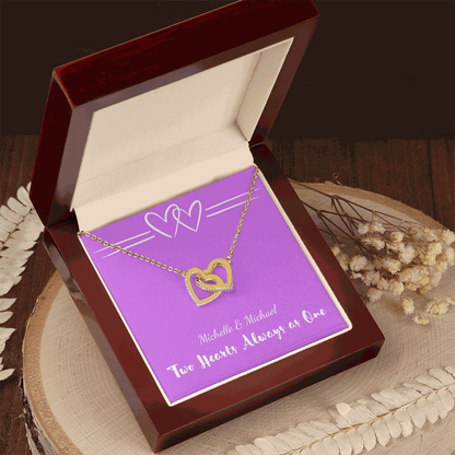 Interlocking Hearts necklace with two gold heart pendants in a luxury gift box