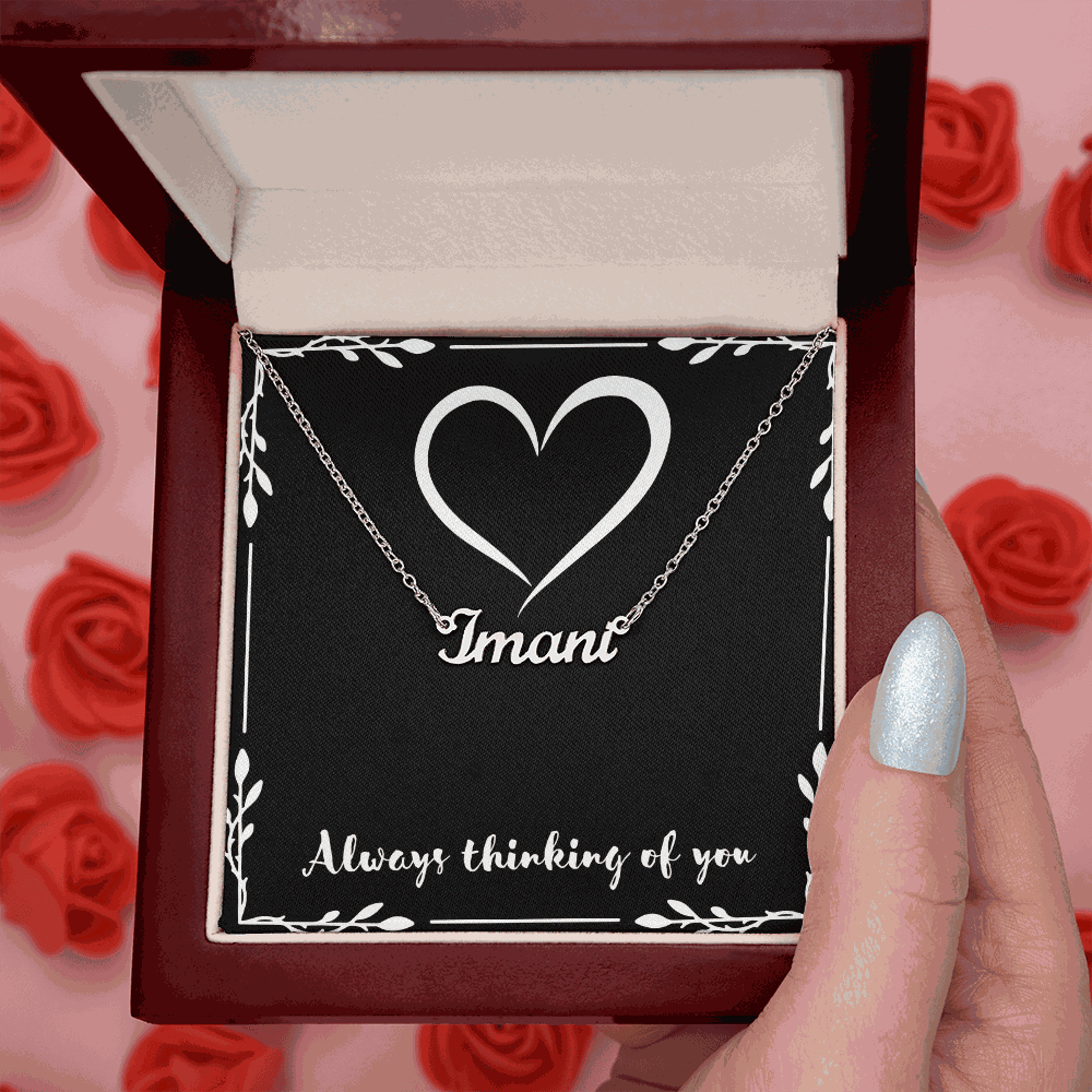 Custom Name Necklace in silver cursive script personalized with the name "Imani" inside a red velvet gift box with a heart design and the phrase "Always thinking of you"