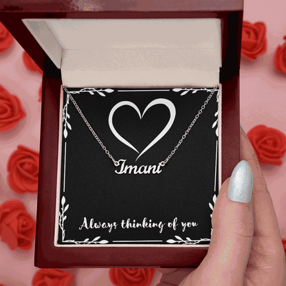 Custom Name Necklace in silver cursive script personalized with the name "Imani" inside a red velvet gift box with a heart design and the phrase "Always thinking of you"