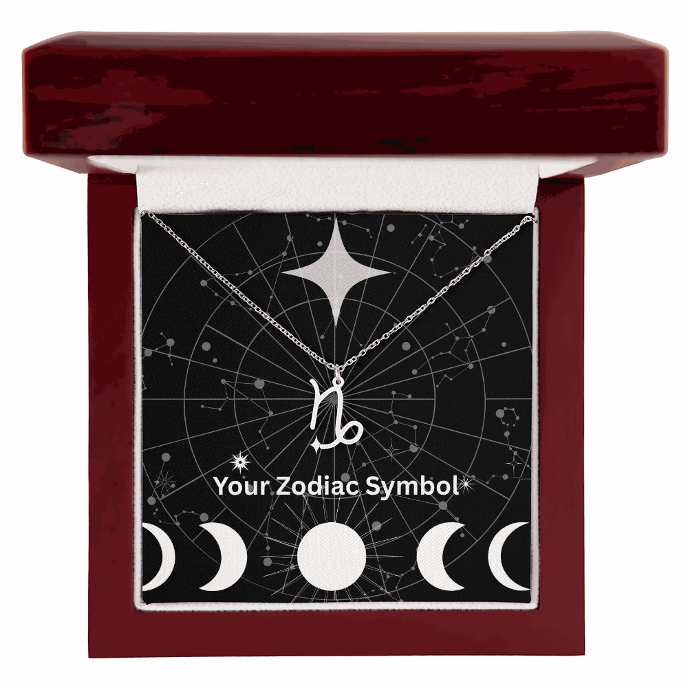 Zodiac symbol necklace on silver chain in mahogany jewelry box with constellation background
