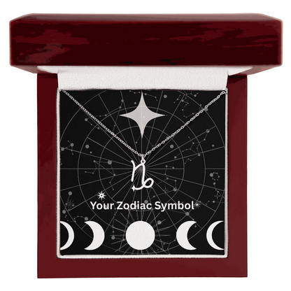 Zodiac symbol necklace on silver chain in mahogany jewelry box with constellation background