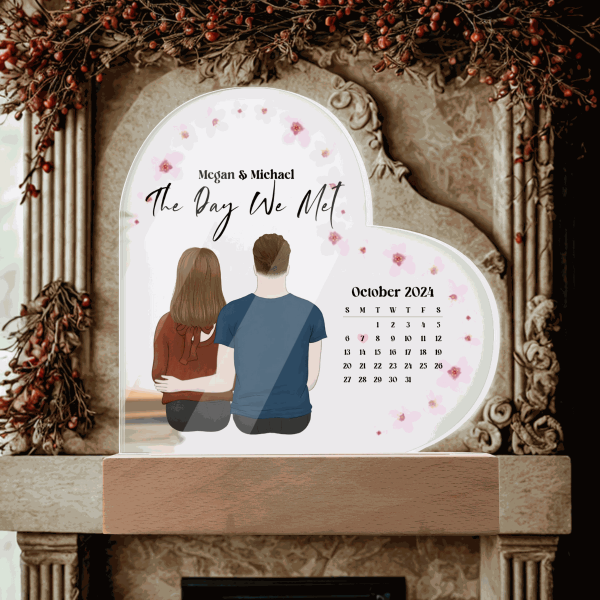 Personalized acrylic heart plaque with couple illustration, calendar, and "The Day We Met" inscription, ideal keepsake gift for anniversaries or weddings.
