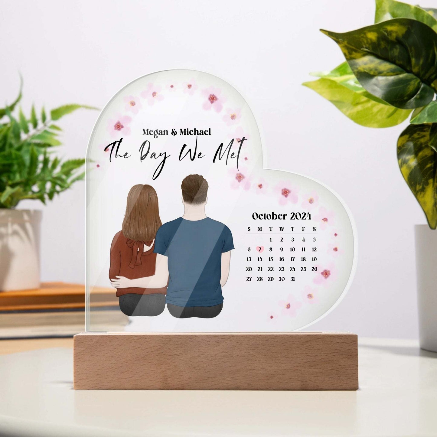 Personalized acrylic heart plaque with calendar and couple illustration commemorating The Day We Met, elegant keepsake on wooden base
