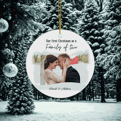 Customizable First Christmas Family Ornament with couple photo and family of two text hanging on snowy Christmas tree