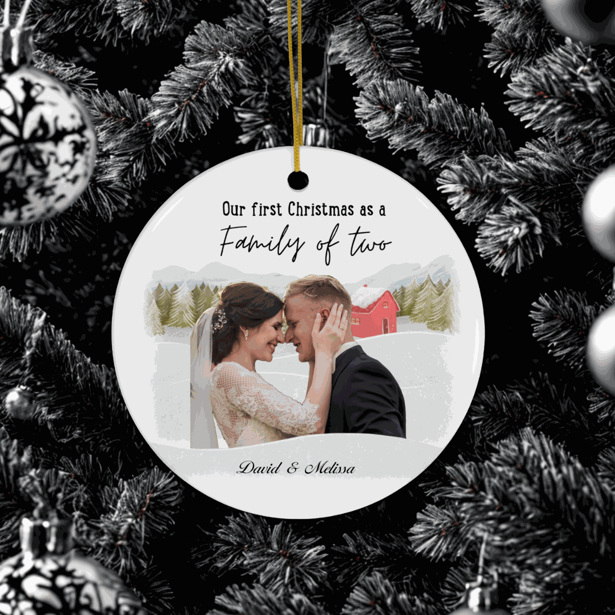 First Christmas Family Ornament personalized with couple's photo and names, hanging on Christmas tree.