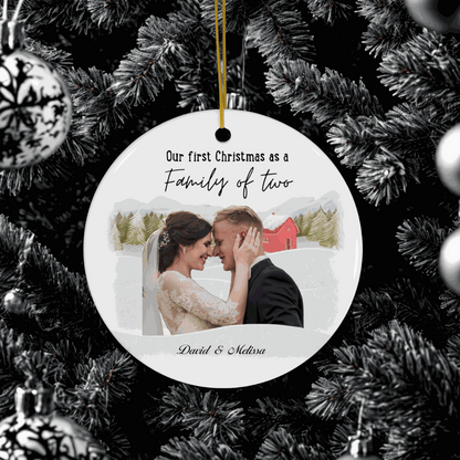 First Christmas Family Ornament personalized with couple's photo and names, hanging on Christmas tree.